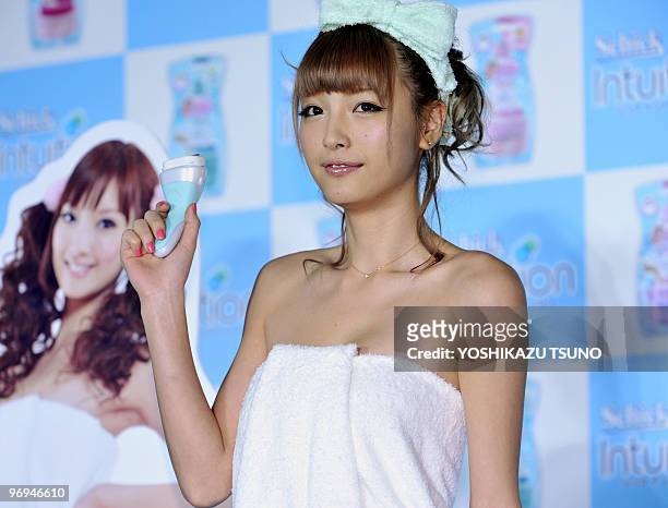 Japanese model Yukina Kinoshita, wrapped in a bath towel, displays the four-blade razor for women called the "Schick Intuition" at a sales promotion...