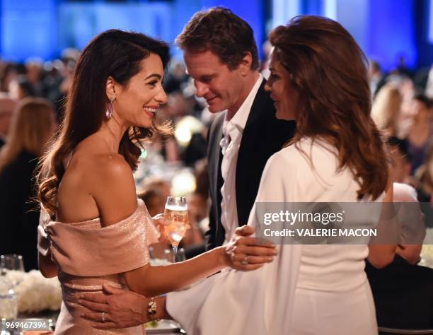 British-Lebanese barrister Amal Clooney talks with US model Cindy Crawford and her husband Rande Gerber at the 46th American Film Institute Life...