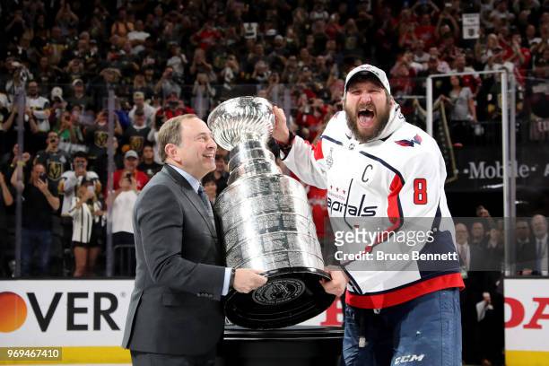 Alex Ovechkin of the Washington Capitals is presented the Stanley Cup by NHL Commissioner Gary Bettman after his team defeated the Vegas Golden...