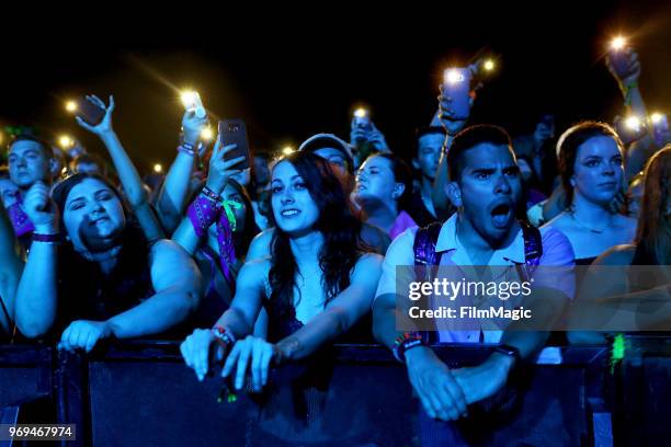 Festival goers watch Chase Atlantic perform onstage at This Tent during day 1 of the 2018 Bonnaroo Arts And Music Festival on June 7, 2018 in...