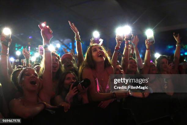 Festival goers watch Chase Atlantic perform onstage at This Tent during day 1 of the 2018 Bonnaroo Arts And Music Festival on June 7, 2018 in...