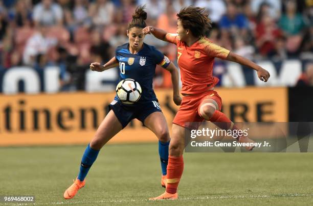 Carli Lloyd of the United States and Wang Shuang of China try for the ball in the second half of an international friendly soccer match at Rio Tinto...