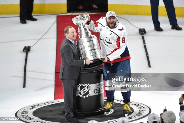 Gary Bettman presents the Stanley Cup to Alex Ovechkin of the Washington Capitals celebrates after defeating the Vegas Golden Knights in Game Five of...