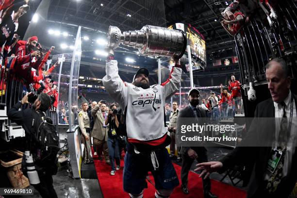 Alex Ovechkin of the Washington Capitals carries the Stanley Cup off the ice after his team defeated the Vegas Golden Knights 4-3 in Game Five of the...