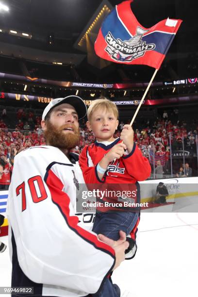 Braden Holtby of the Washington Capitals celebrates with his son Benjamin Holtby after the Capitals' win over the Vegas Golden Knights in Game Five...