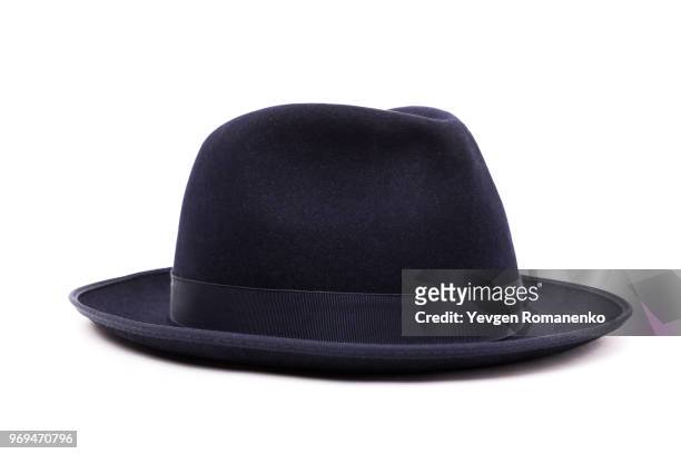 a classic low crown fedora hat in a dark blue color. isolated on white background. - hat stockfoto's en -beelden