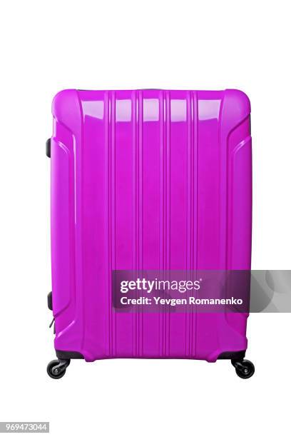 lilac travel bag on a black wheels, isolated on white background. - equipaje de mano fotografías e imágenes de stock