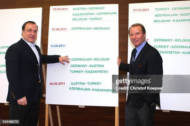 National coach Dick Advocaat of Belgium and national coach Berti Vogts of Azerbaijan pose at the schedule during the meeting of the Euro 2012...