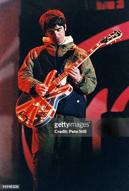 Noel Gallagher of Oasis performs on stage playing his iconic Union Jack Epiphone guitar, at Maine Road Stadium on April 28th, 1996 in his home town...