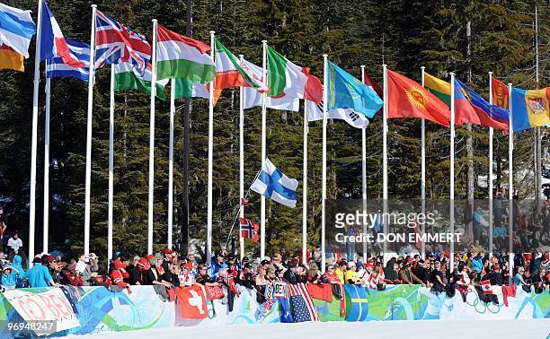 Flags flutter as fans watch the men's Cross Country Skiing 30km pursuit final at the Whistler Olympic Park during the Vancouver Winter Olympics on...