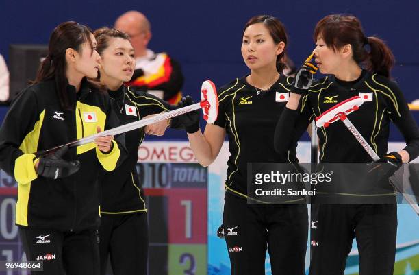 Moe Meguro, Mari Motohashi, Anna Ohmiya and Kotomi Ishizaki of Japan look on during the women's curling round robin game between Japan and Germany on...