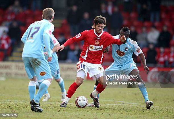 James Bailey of Crewe Alexandra looks to move between Billy McKay and Abdul Osman of Northampton Town during the Coca Cola League Two Match between...