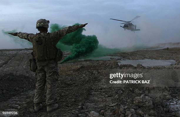 Army Blackhawk helicopter lands near a marine combat outpost in Trikh Nawar, a poppy farmland area on the northeastern outskirts of Marjah, on...