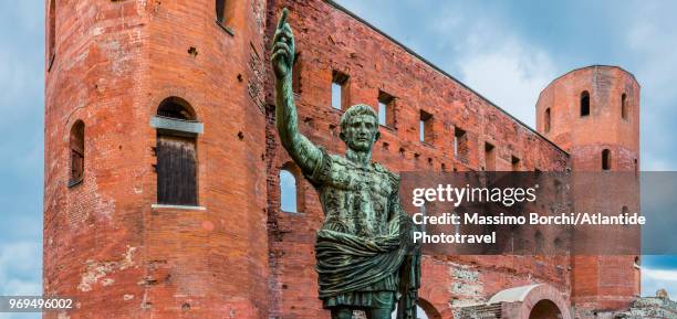 view of porta palatina (palatine gate), on the foreground the bronze replica statue of the roman emperor augustus caesar - porta palatina stock pictures, royalty-free photos & images
