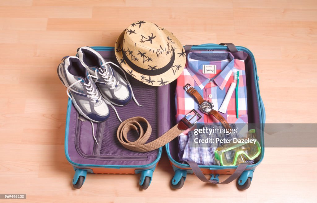 MAN PACKING FOR VACATION
