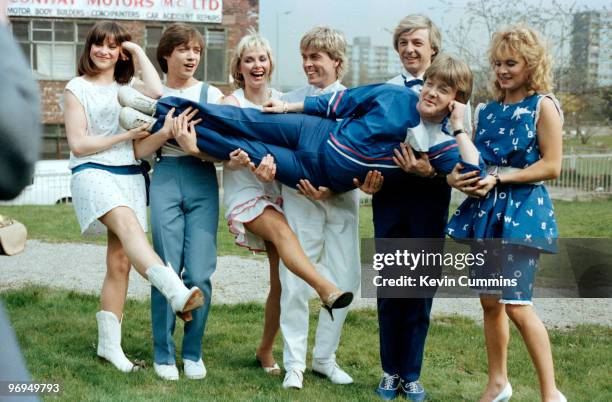 Cheryl Baker, Mike Nolan, Bobby G and Jay Aston of Eurovision winners Bucks Fizz hold up television presenter Keith Chegwin in 1981.