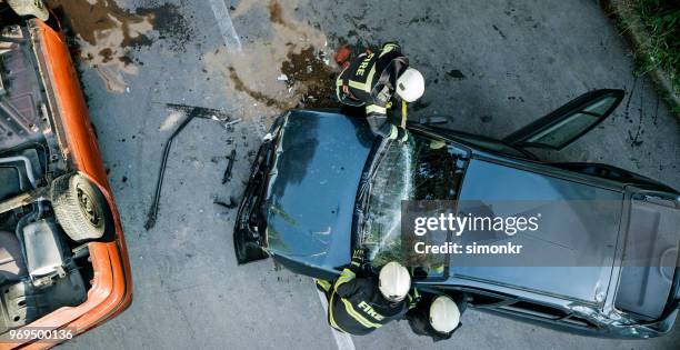 car accident - fireman stock-fotos und bilder