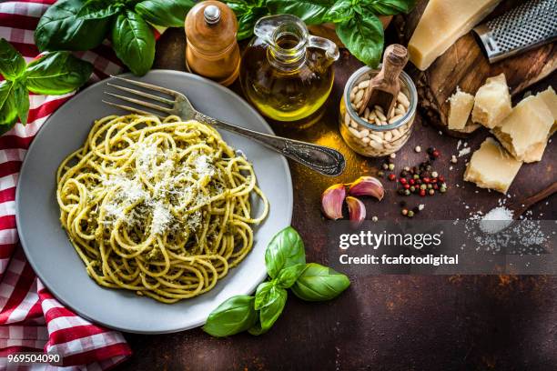 pasta al pesto plate on dark kitchen table - genoese stock pictures, royalty-free photos & images