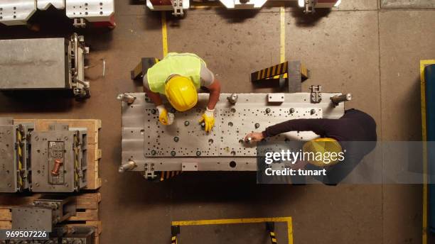 manuel trabajador en una línea de producción de una pieza de la máquina - manufacturing equipment fotografías e imágenes de stock