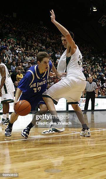 Tim Anderson of the U.S. Air Force Academy drives past Stuart Creason during a game against Colorado State University at Moby Arena, Fort Collins,...