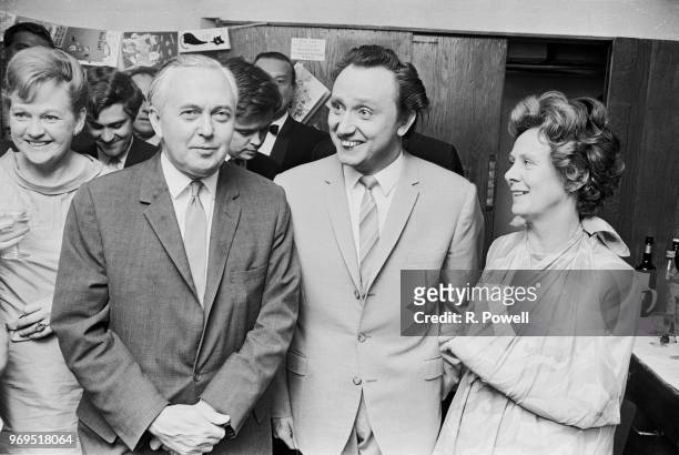 British Prime Minister of the United Kingdom Harold Wilson with his wife, English poet Mary Wilson, and English comedian Ken Dodd backstage after the...