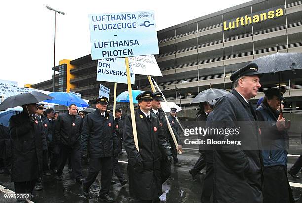 Lufthansa pilots demonstrate with a sign reading "Lufthansa airplanes, Lufthansa pilots" at Rhein-Main Airport in Frankfurt, Germany, on Monday, Feb....