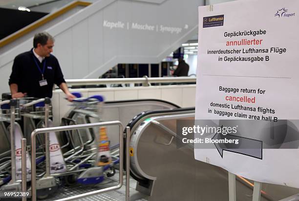 Sign tells passengers whose flights have been cancelled where to pick up their baggage at Rhein-Main Airport in Frankfurt, Germany, on Monday, Feb....