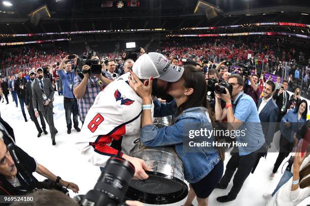 Alex Ovechkin of the Washington Capitals kisses his wife Anastasia Shubskaya, while holding the Stanley Cup, after his team's 4-3 win over the Vegas...