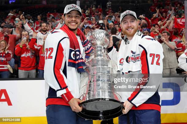 Madison Bowey and Travis Boyd of the Washington Capitals pose with the Stanley Cup after their team's 4-3 win over the Vegas Golden Knights in Game...