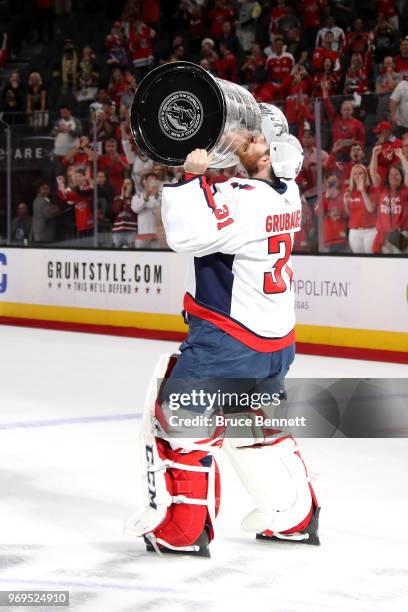 Philipp Grubauer of the Washington Capitals hoists the Stanley Cup after his team defeated the Vegas Golden Knights 4-3 in Game Five of the 2018 NHL...