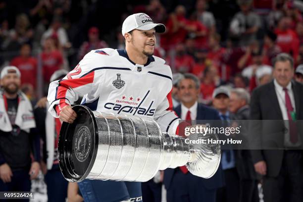 Madison Bowey of the Washington Capitals hoists the Stanley Cup after his team defeated the Vegas Golden Knights 4-3 in Game Five of the 2018 NHL...