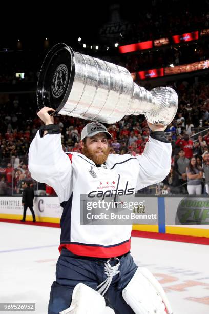 Braden Holtby of the Washington Capitals hoists the Stanley Cup after his team defeated the Vegas Golden Knights 4-3 in Game Five of the 2018 NHL...