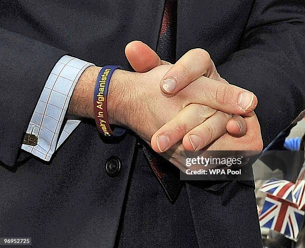 Prince William wears a 'support the Household cavalry in Aftganistan' wristband as he makes a visit to Alder Hey Children's Hospital to officially...