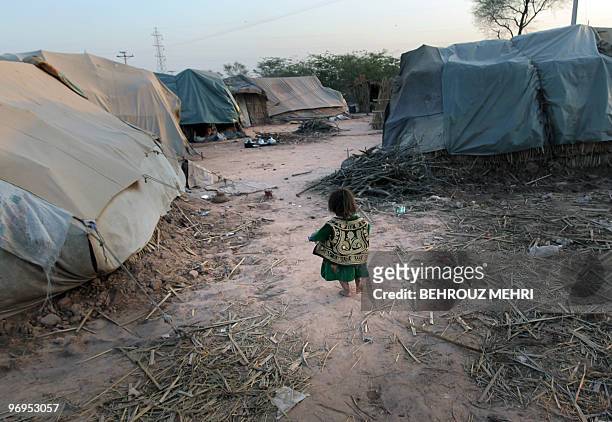 Pakistani ethnic Pashtun girl walks towards her makeshift tent in the town of Khewra some 200 kms south of the capital Islamabad on February 14,...