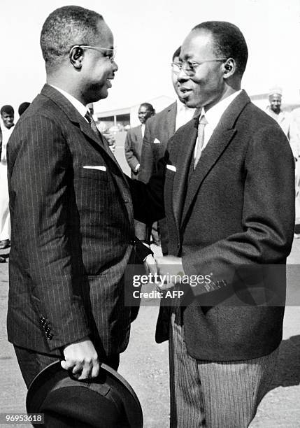 Leopold Sedar Senghor , president of Senegal, welcomes Ahmadou Ahidjo, President of Cameroon, on March 5, 1964 for a state visit, at Dakar Airport.