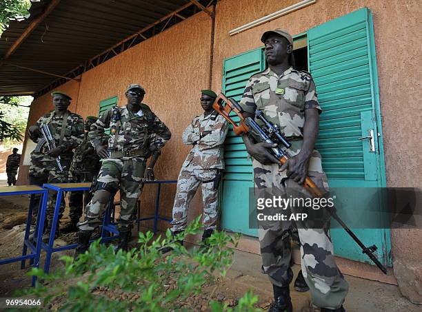 Niger's soldiers stand guard outside the office of Salou Djibo, leader of the coup that overthrew president Mamadou Tandja, on February 21, 2010 at a...
