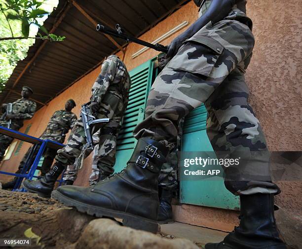 Niger's soldiers stand guard outside the office of Salou Djibo, leader of the coup that overthrew president Mamadou Tandja, on February 21, 2010 at a...