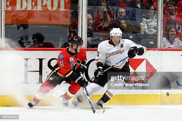 Ian White of the Calgary Flames skates against Corey Perry of the Anaheim Ducks on February 13, 2010 at Pengrowth Saddledome in Calgary, Alberta,...