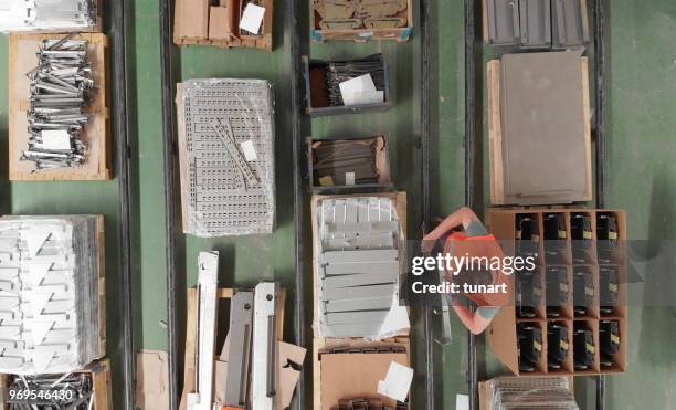 quality control technician checking manufactured goods - sweatshop stock pictures, royalty-free photos & images