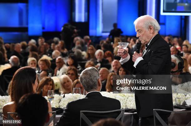 Actor George Clooney , flanked by his wife British-Lebanese barrister Amal Clooney , listens as his father Nick Clooney delivers a toast at the 46th...