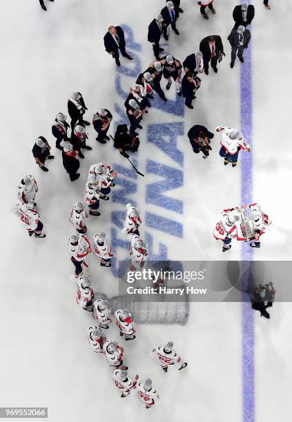 Jakub Vrana hands the Stanley Cup to Alex Chiasson of the Washington Capitals after their team's 4-3 win over the Vegas Golden Knightsin Game Five of...