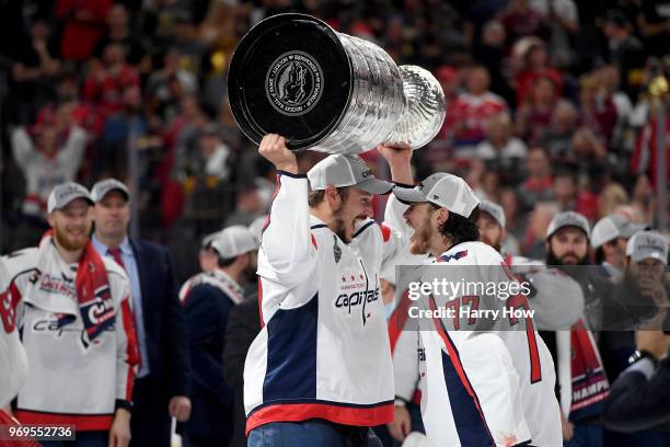 Oshie hands the Stanley Cup to Jay Beagle of the Washington Capitals after their team defeated the Vegas Golden Knights 4-3 in Game Five of the 2018...