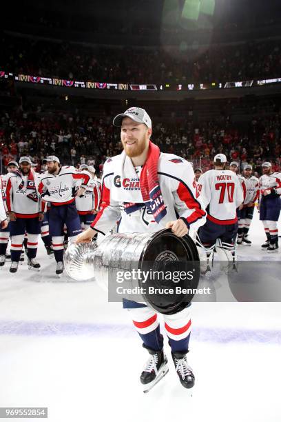 Lars Eller of the Washington Capitals hoists the Stanley Cup after his team's 4-3 win over the Vegas Golden Knights in Game Five of the 2018 NHL...
