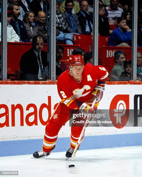 Al MacInnis of the Calgary Flames skates with the puck against the Montreal Canadiens in the late 1980's at the Montreal Forum in Montreal, Quebec,...