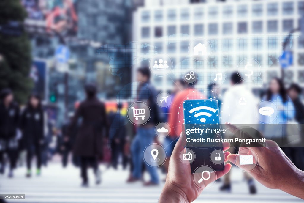 Touching social icon on screen connect internet and network all device technology with city background of business in blue tone, business and technology concept