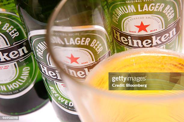 Bottles of Heineken beer, brewed by Heineken NV sit arranged for a photograph in London, U.K., on Monday, Feb. 22, 2010. Heineken NV's U.S.-traded...