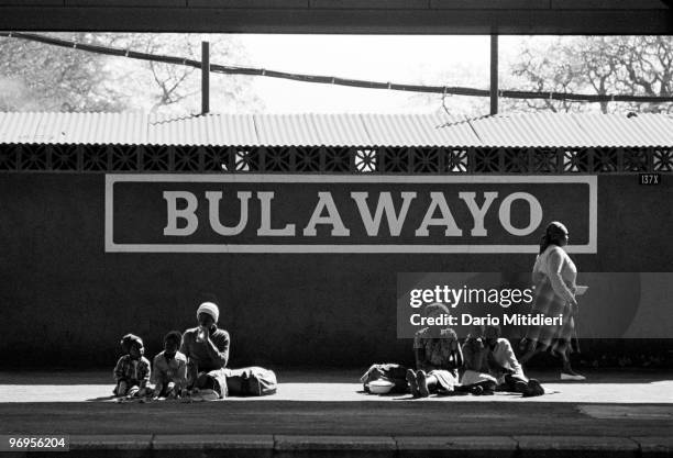 Women and children waiting for a train at Bulawayo station, Zimbabwe.