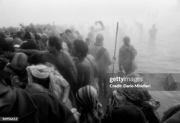 Hindus pilgrims bathing at the 'Sangam', the confluence of the Yamuna, Ganges and the mytical Saraswati rivers, during the Kumbh Mela festival at...