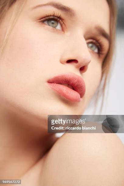 beauty portrait of a woman witl blue eyes and natural make up face detail - blue lips stock pictures, royalty-free photos & images