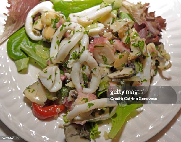 seafood salad with italian bread on the side served on christmas eve as part of the feast of the seven fishes. - side salad stock pictures, royalty-free photos & images